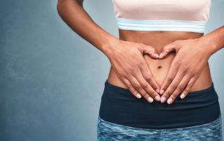 Digestive Health woman with hands on abdomen
